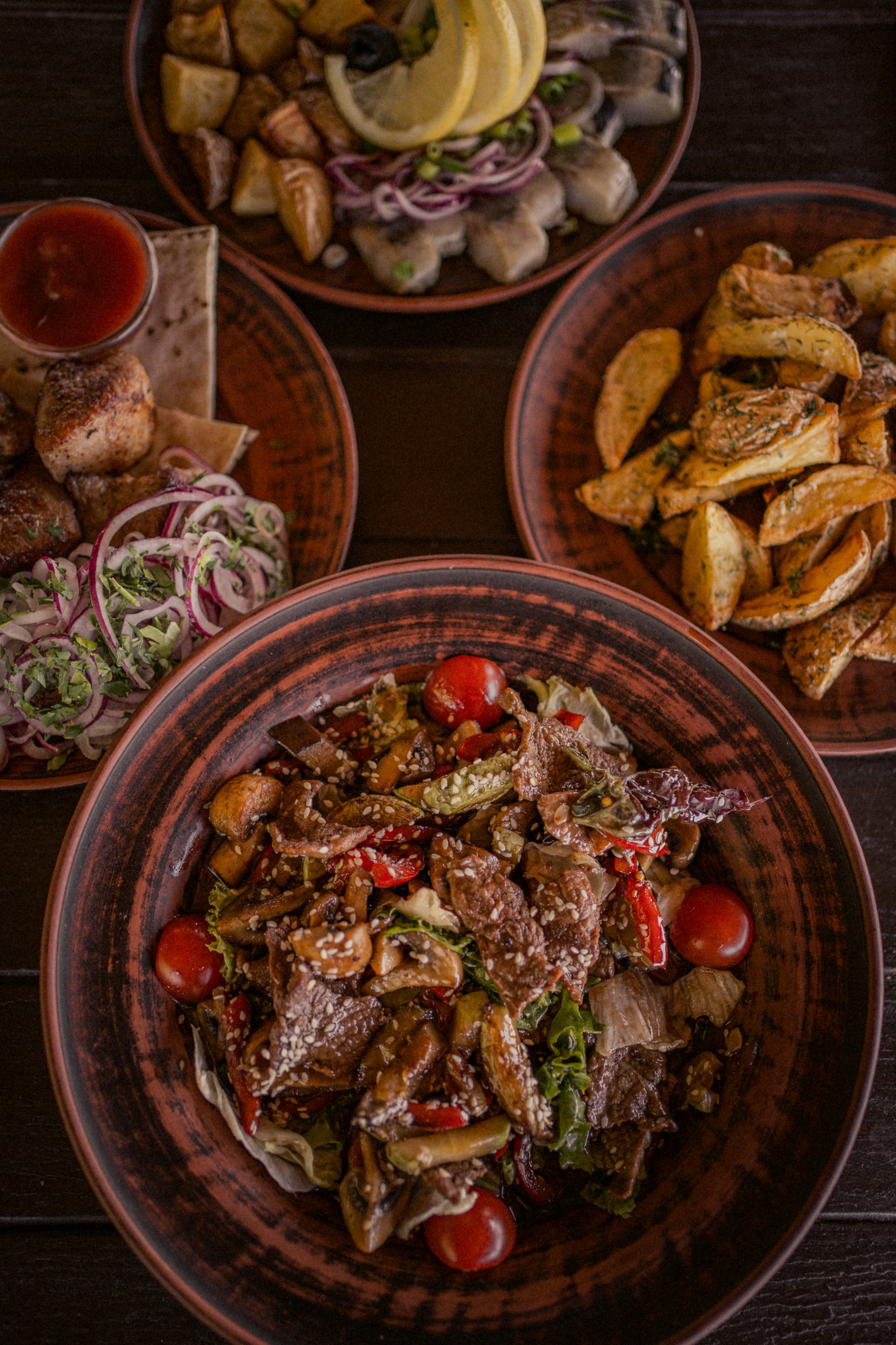 Several restaurant dishes on one table